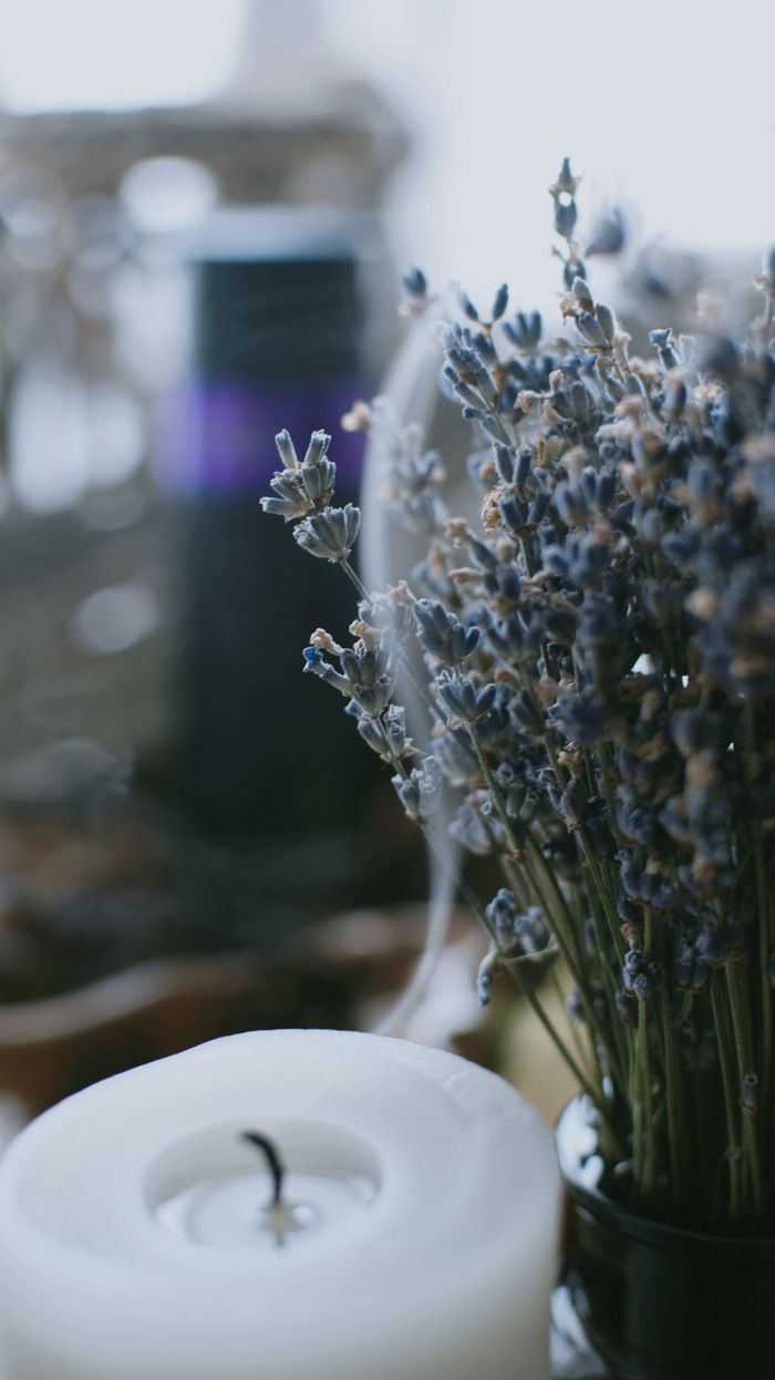 About Close-up of lavender flowers with a candle, creating a serene and calming atmosphere.