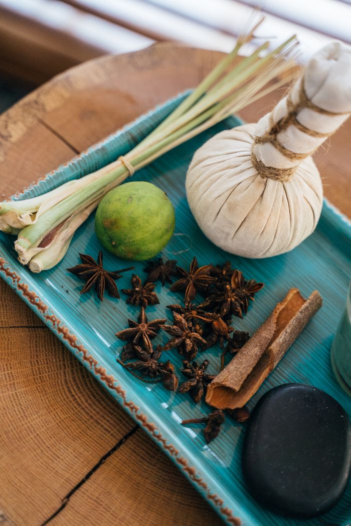Mastering the First Impression: Your intriguing post title goes here Flat lay of aromatic herbs and spa elements on a rustic tray for holistic beauty treatment.